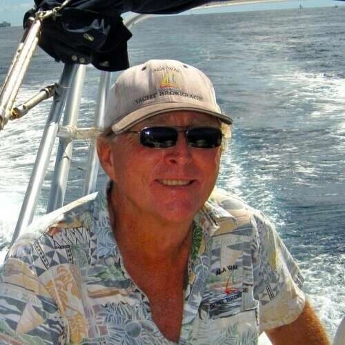 John Dukesherer, yacht broker, at the helm off Honolulu